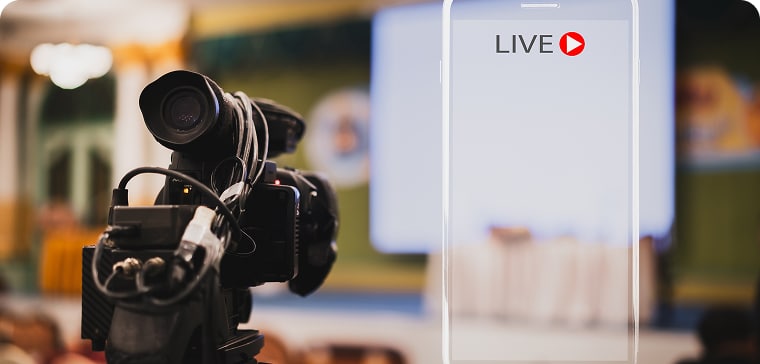 A video camera broadcasting and recording a conference